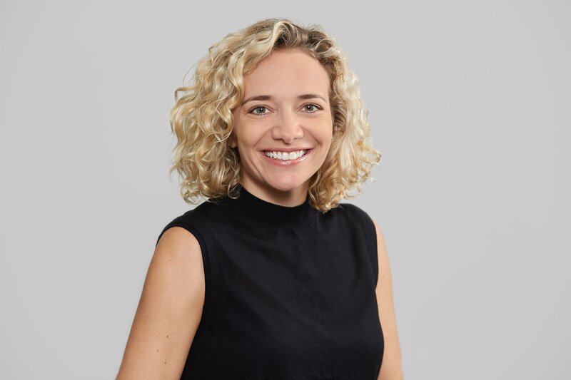Single female staff profile photo with light blurred background