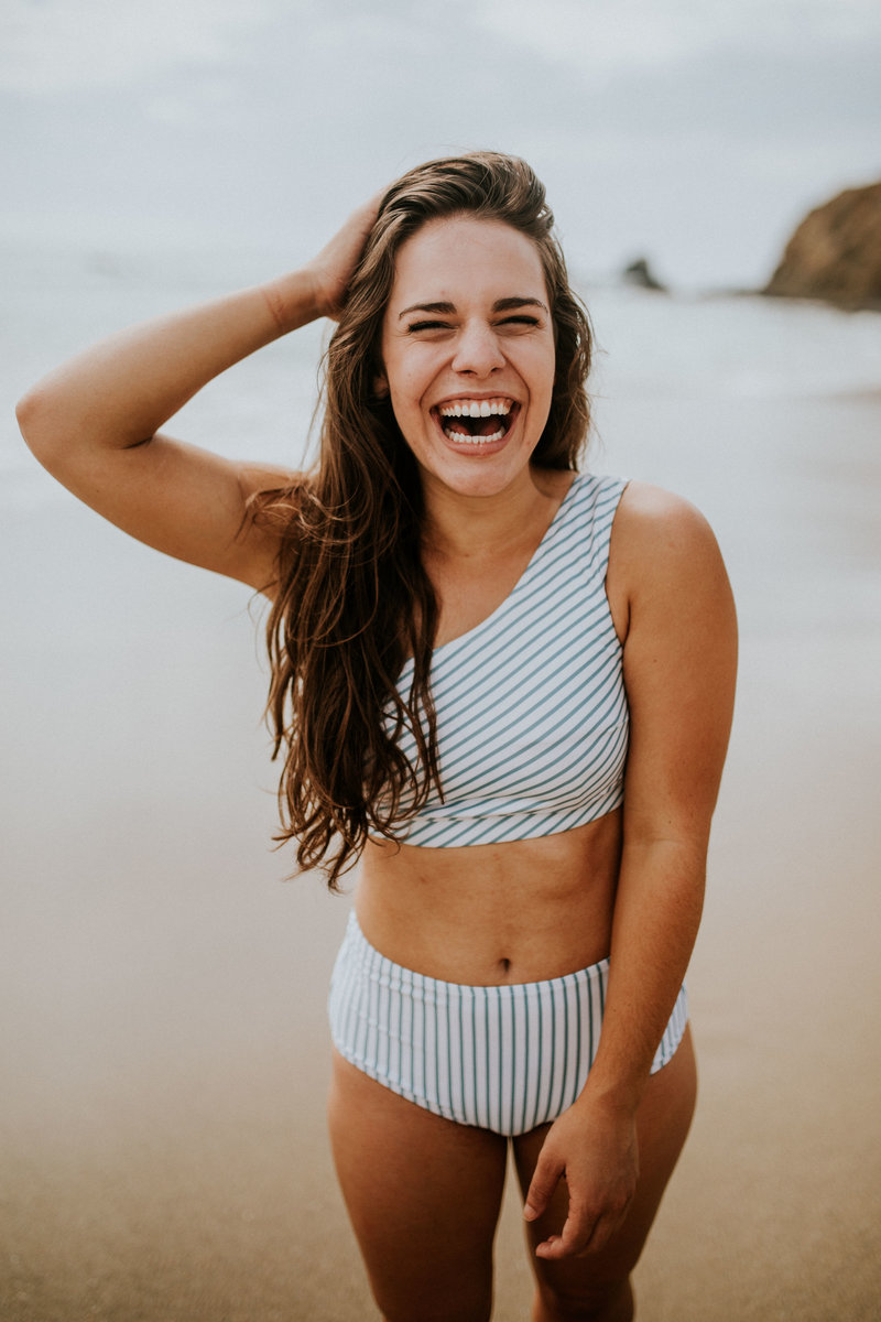 girl laughing at the beach