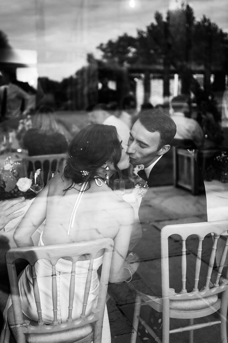 Couple kissing through window Norfolk