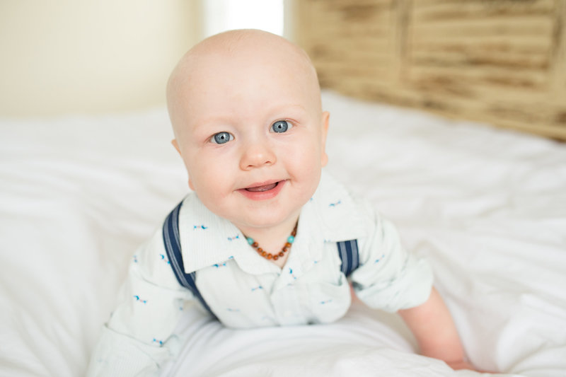 baby sitting on a bed