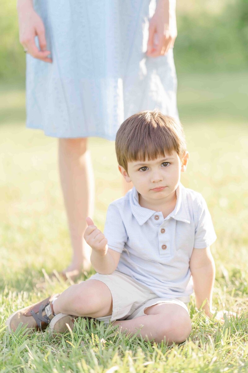 Boy sitting on the grass taken by a Haymarket, VA photographer