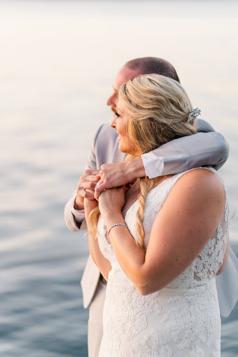 Couple hugging during sunset on the water | Maine elopement photographer | Adventure and Vows