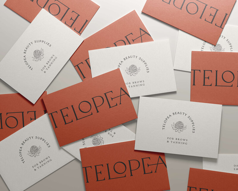 A collection of Telopea Beauty Supplies branded envelopes in muted red and white tones, emphasizing the brand’s cohesive and sophisticated visual identity across different materials.