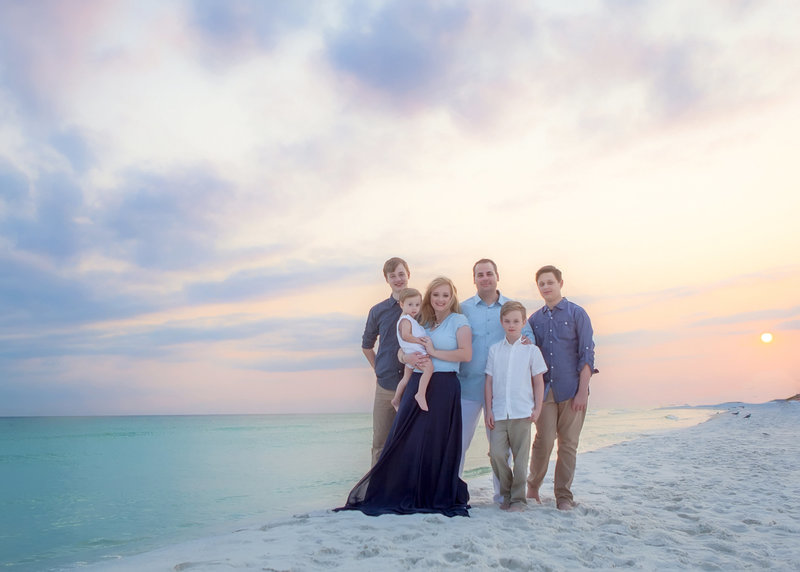 Large family with children standing for a photograph on the beach in destin florida