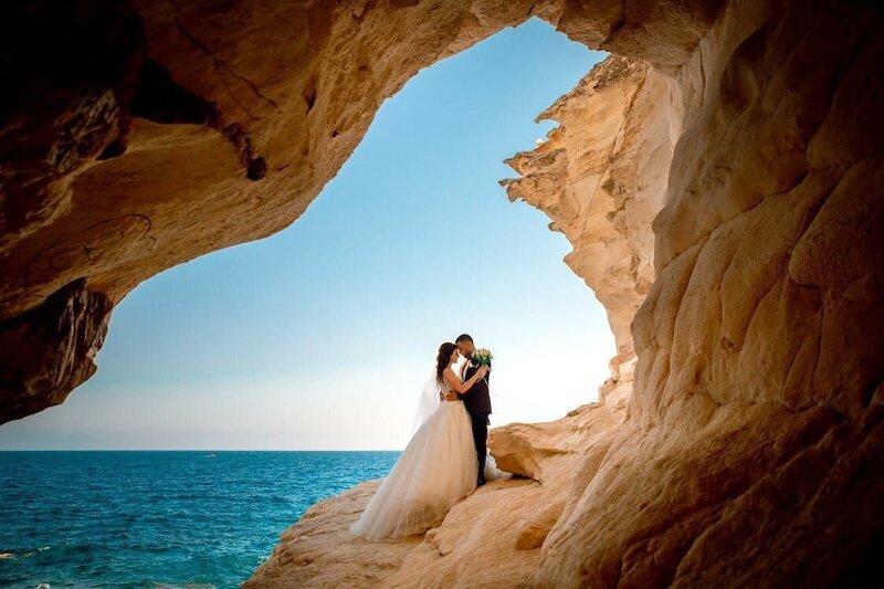 bride and groom over the ocean on their wedding day
