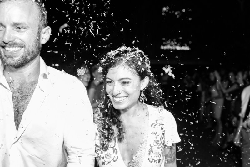 A black and white photo of a couple leaving their Atlanta Georgia wedding in a confetti toss exit.