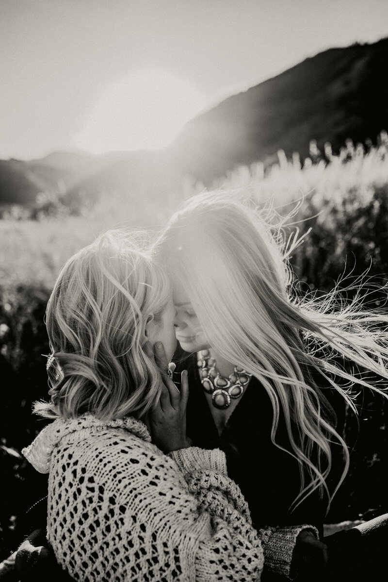 Mom and daughter embracing during a sunset family photoshoot