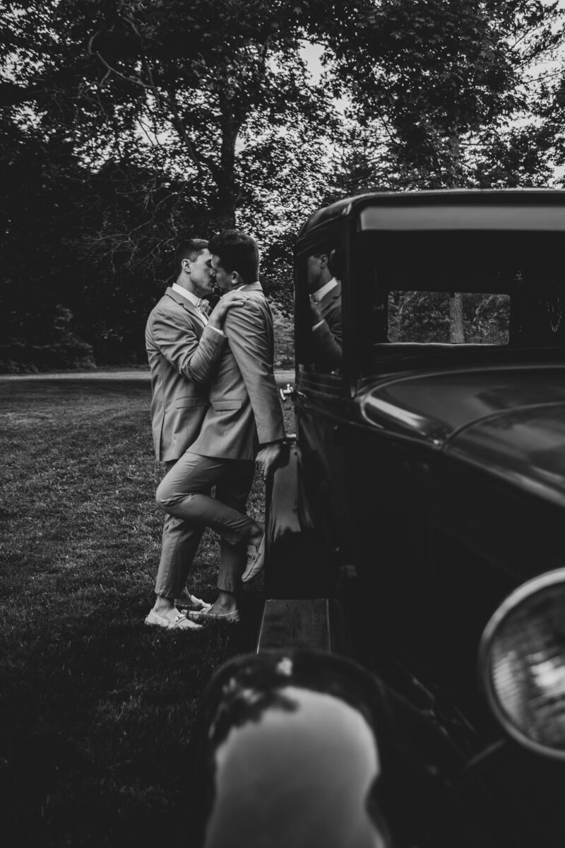 Groom and groom kissing during their Hillcrest Estate wedding captured by Hollenbeck's Photography.