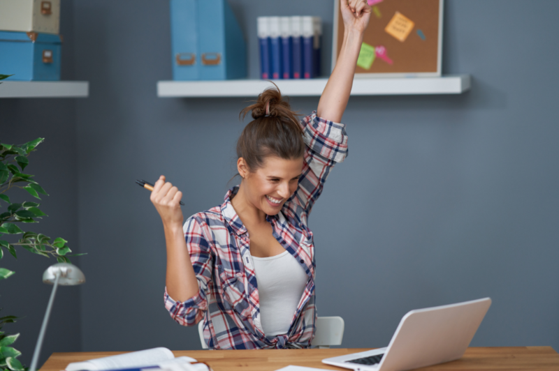 woman with arms raised in excitement because she's learning how to heal her melasma