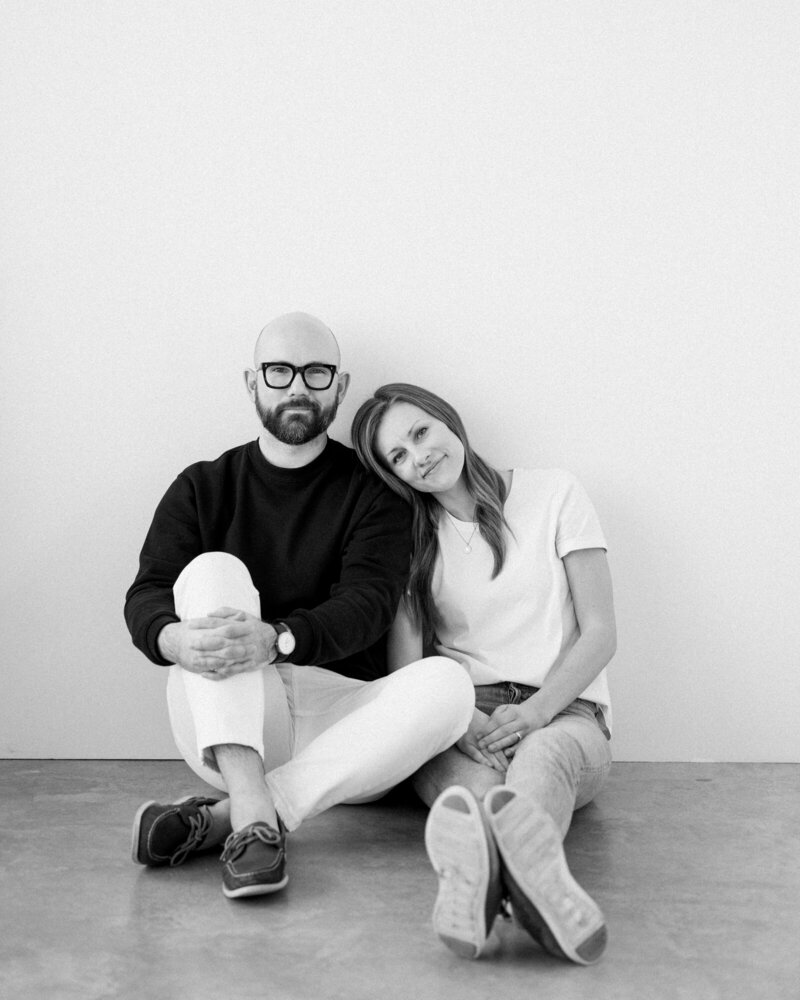 a black and white portrait of Alberta wedding photographers David and Breanne Heidrich at their Okotoks photography studio