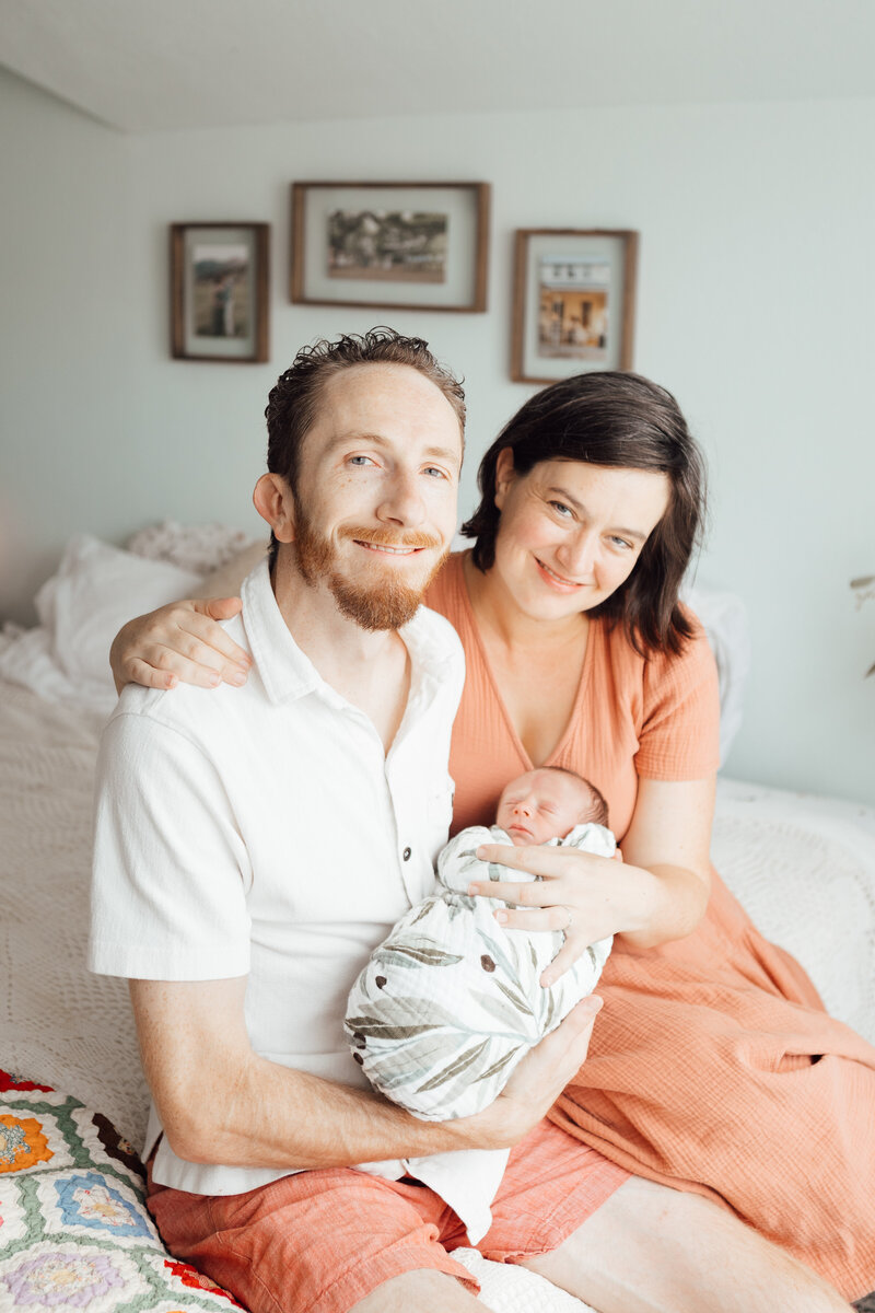 Stephanie Eddy Pierce, and her husband Dylan Scott Pierce holding their newborn son