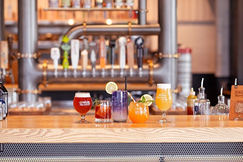 Line up of beautiful hand crafted beverage waiting at the bar to be taken to restaurant patrons