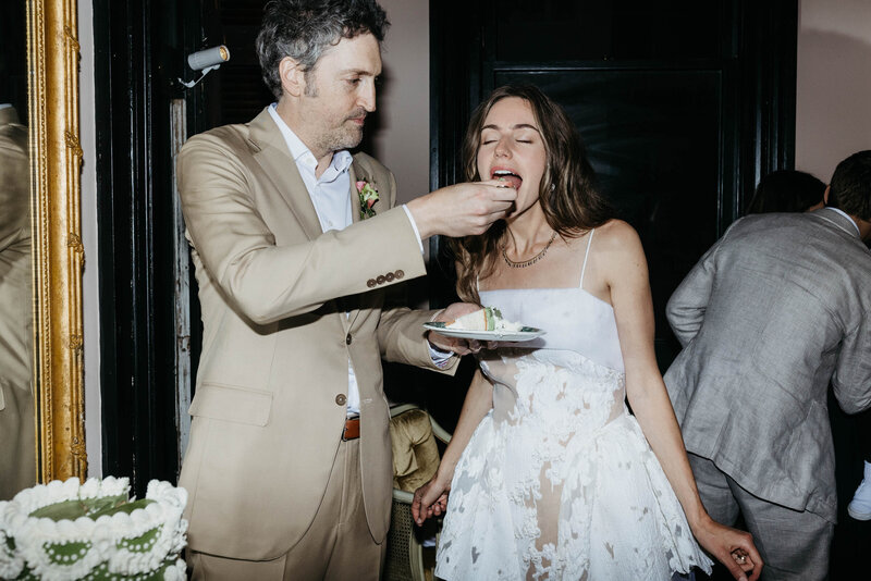 Bride and groom feeding each other cake at their wedding reception at Columns Hotel.