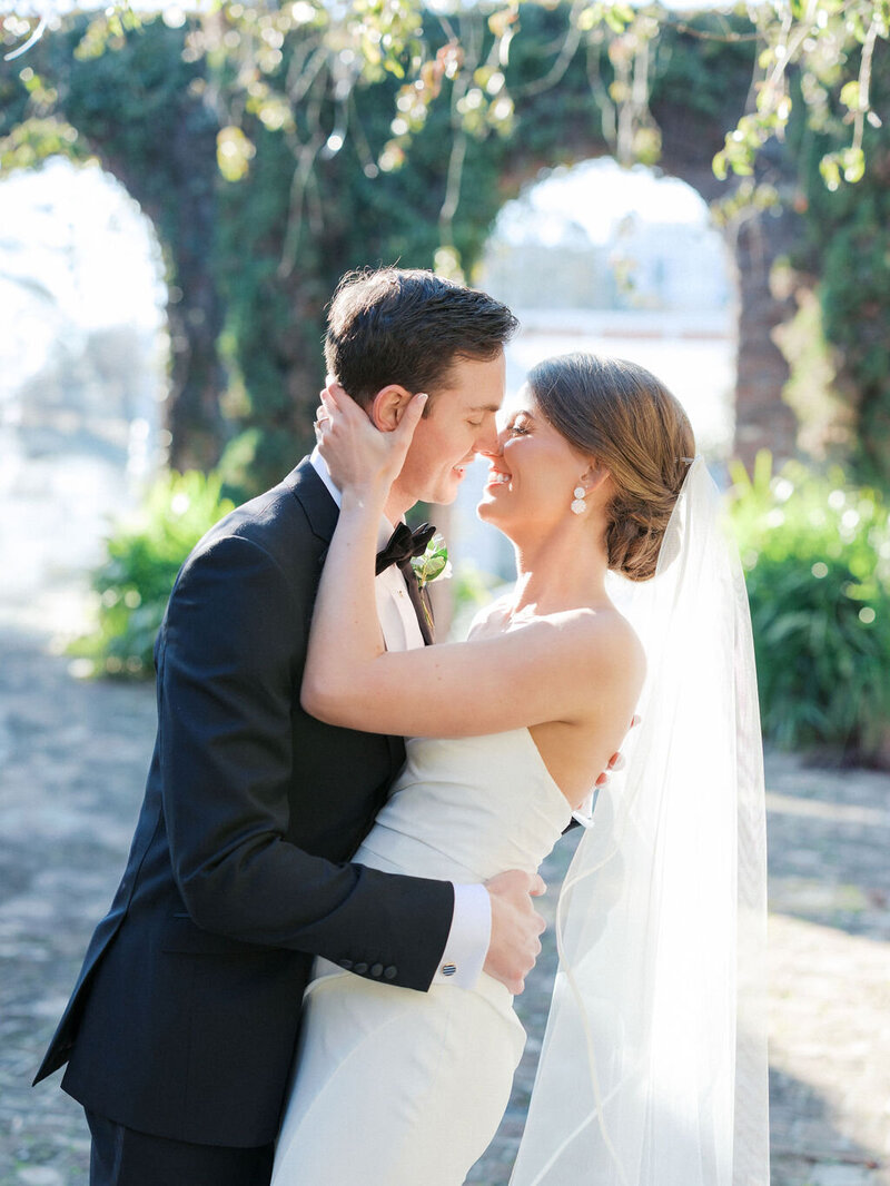 Groom dips bride for a kiss under the arch at Summerour Studio in Atlanta