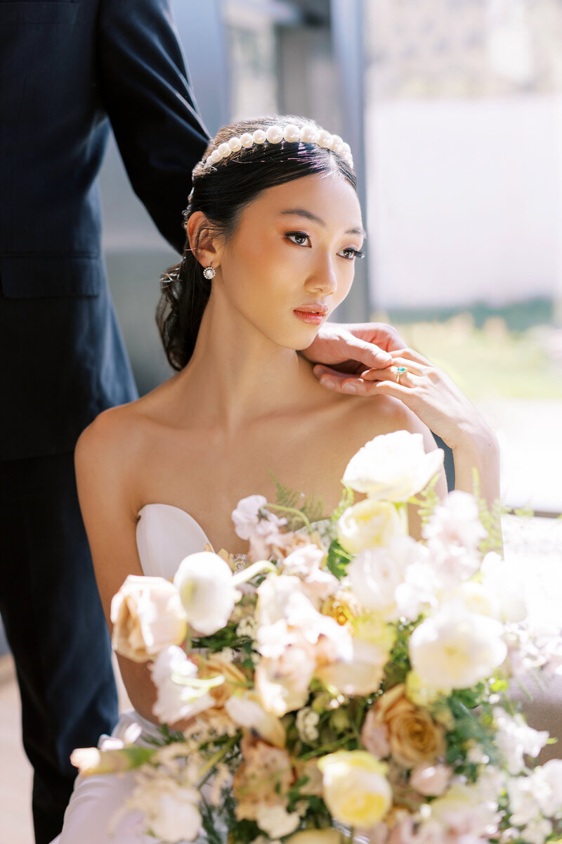 Beautiful asian bride sits in the lobby of the Park City Resort  the Lodge at Blue sky. Captured by Chris Cook Utah wedding photographer