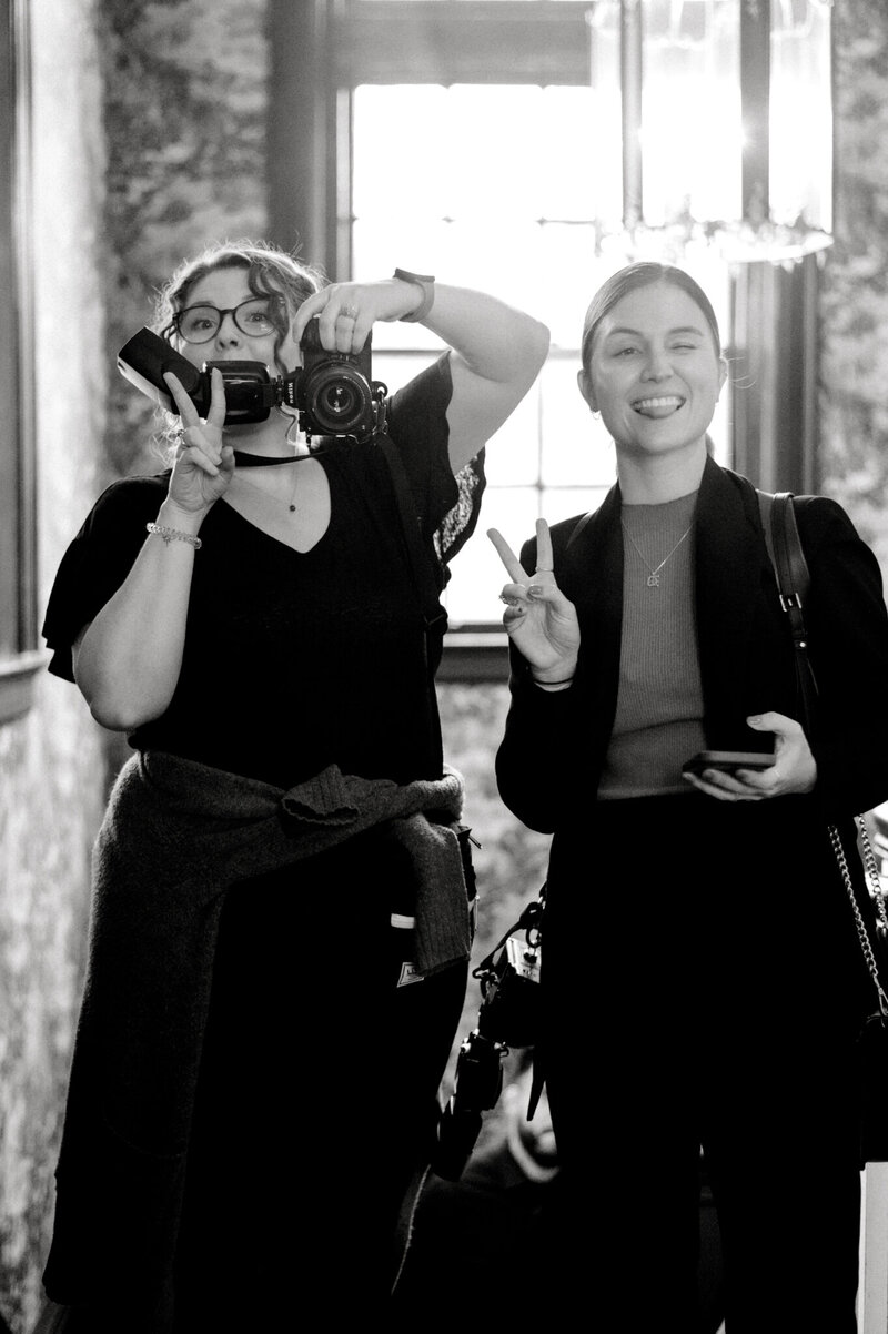 Black and white image of Allison Bolin Texas wedding photographer and her second shooter at a Dallas wedding