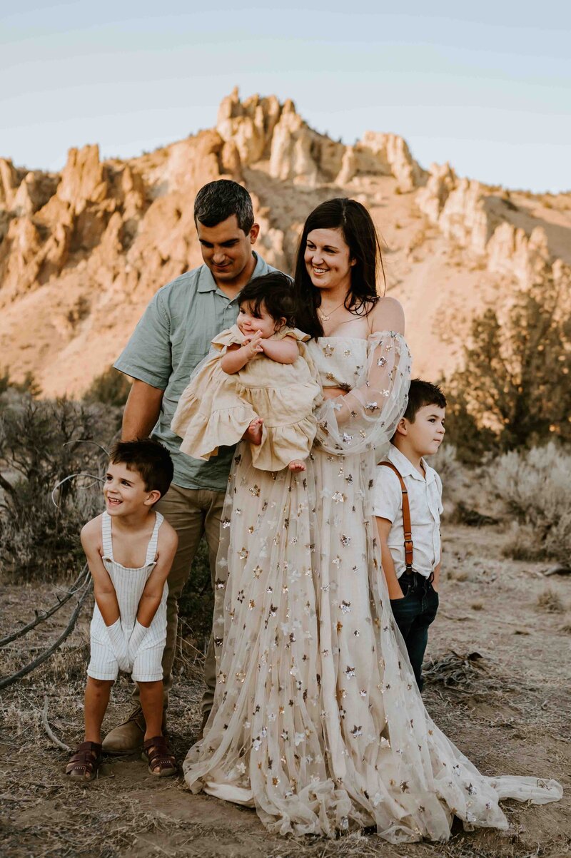 Family of five at Smith Rock smiling together.