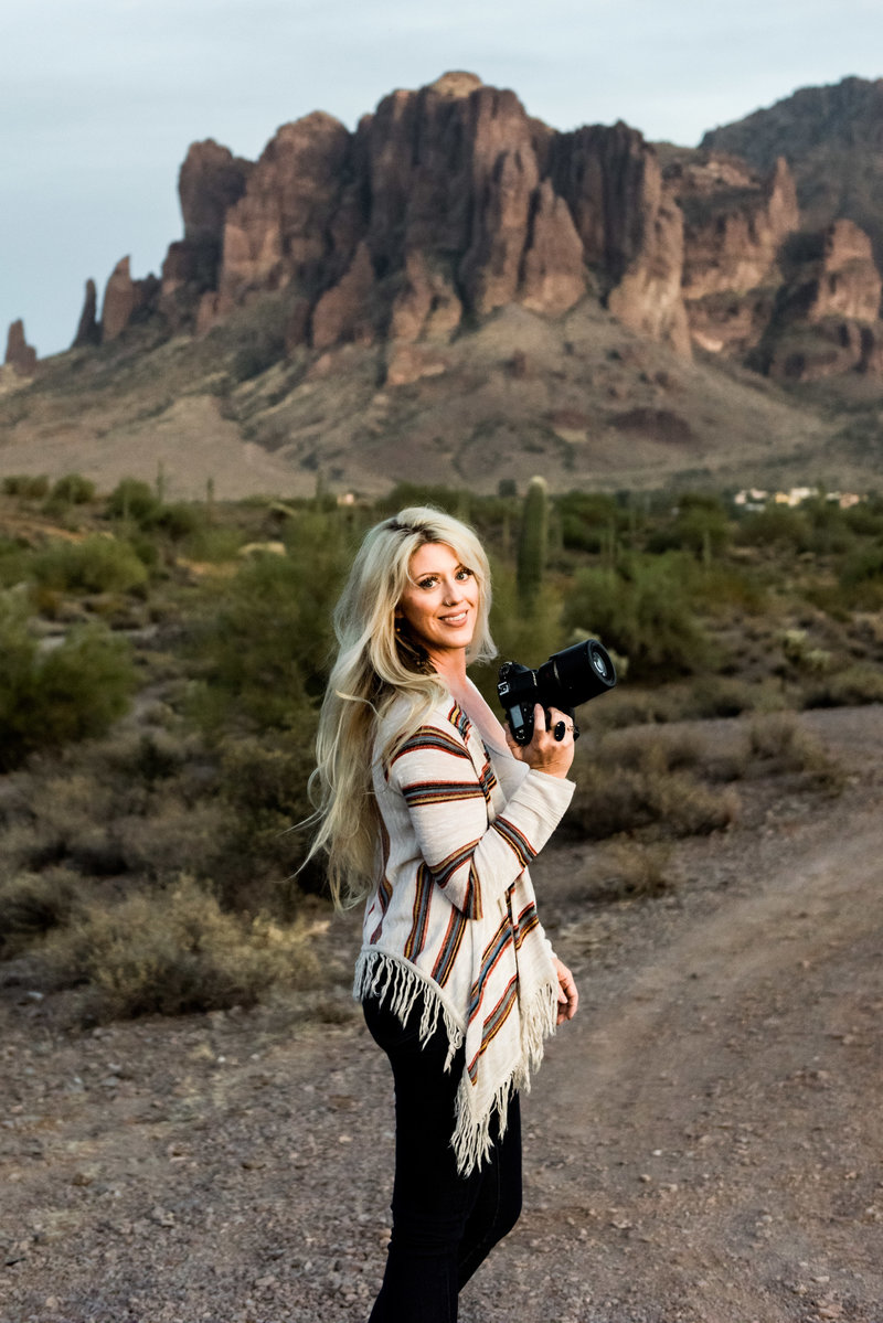 Arizona wedding photographer standing in the desert near Superstiions.