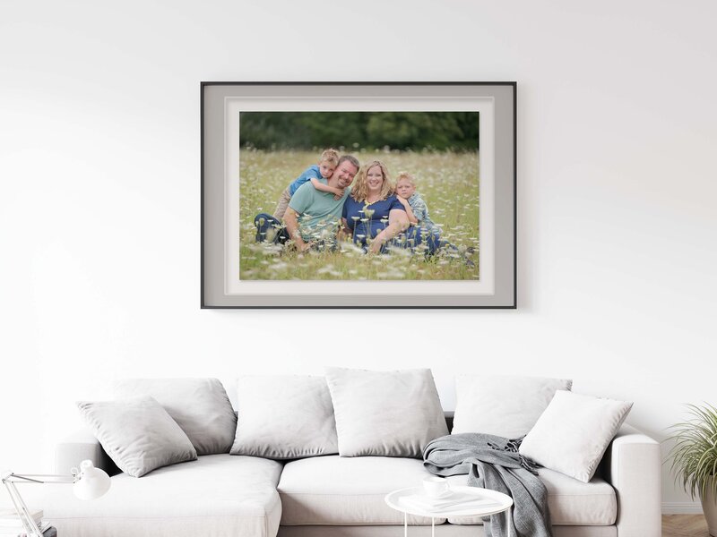 family of 4 sitting down in a field of flowers custom wall art