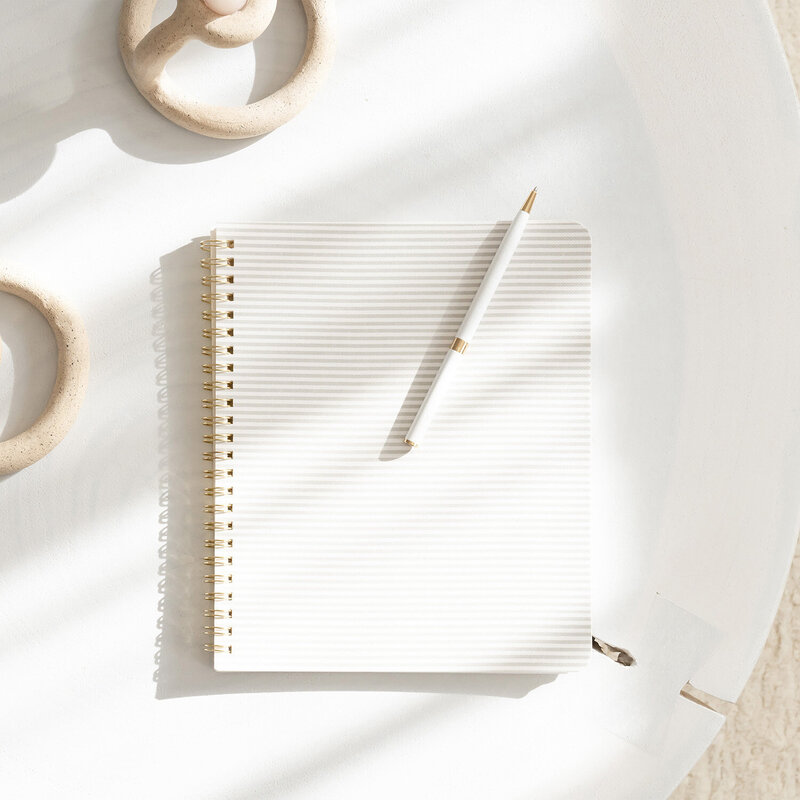 an image of a notebook on a website for online coaching for moms of color in Matrescence.