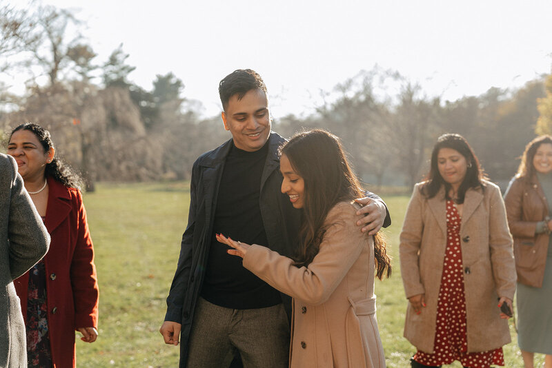 couple admiring ring during surprise proposal photos, captured by Elsie Goodman, an NYC proposal, engagement and couples photographer
