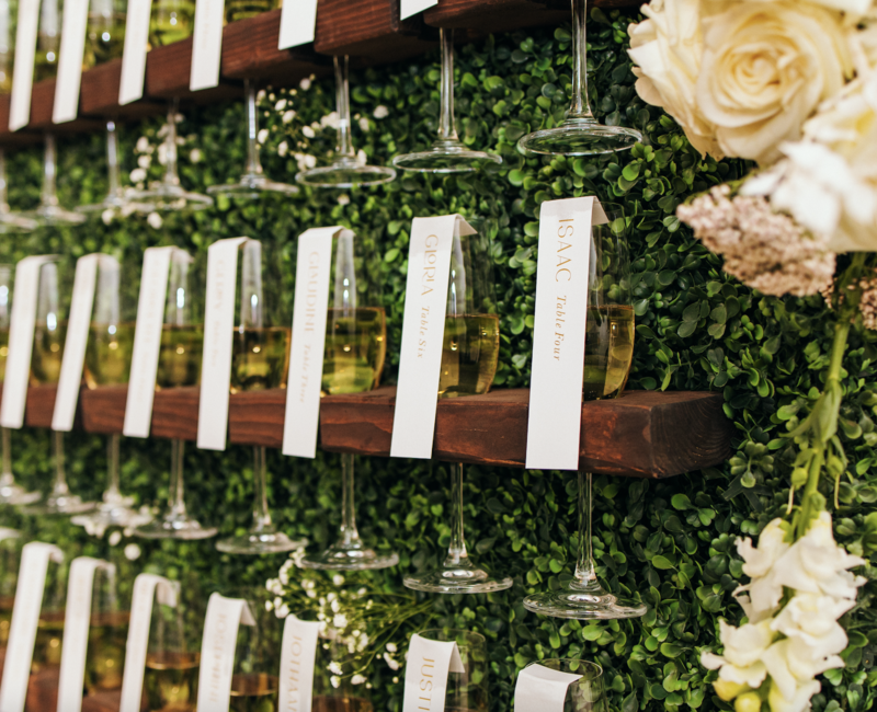 champagne-escort-cards-hedge-wall