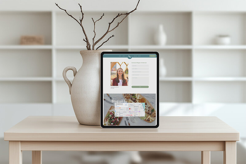 Tablet on a table beside a vase and plant, creating a welcoming atmosphere for a dietitian website.