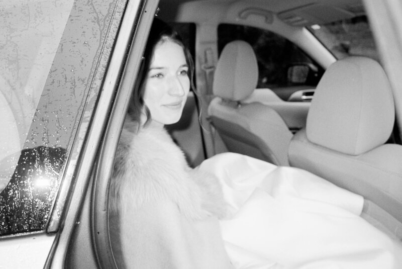 Bride smiling in car