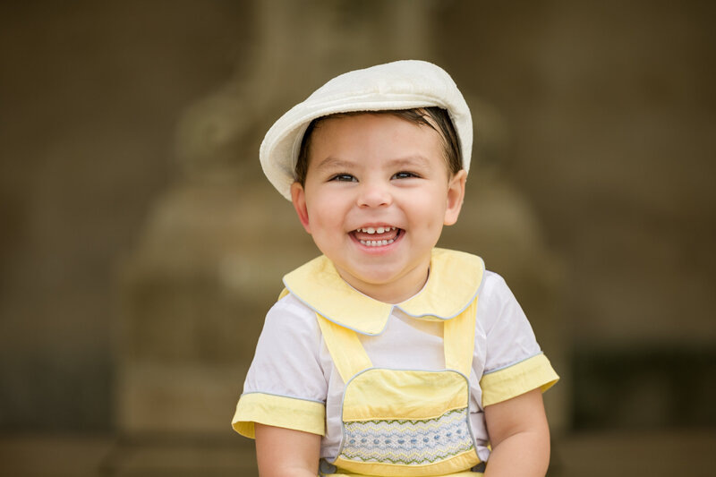 A toddler dressed in an adorable spring outfit sitting solo, basking in the warmth of a spring photography mini session in Valley Forge.