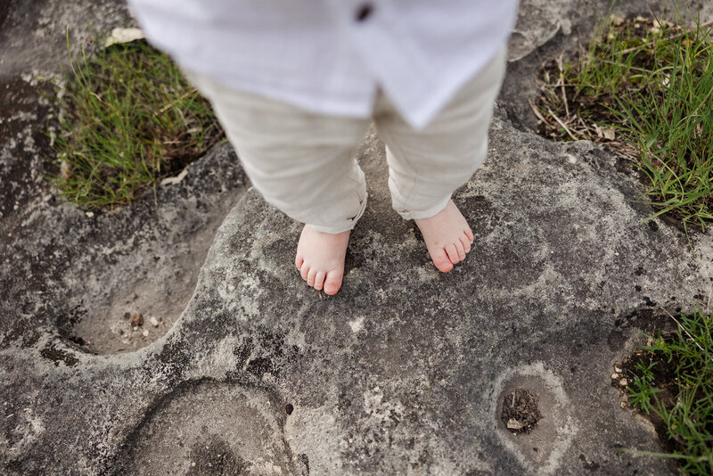 Birds eye view of toddler toes on a rock taken in De Soto, Missouri. 