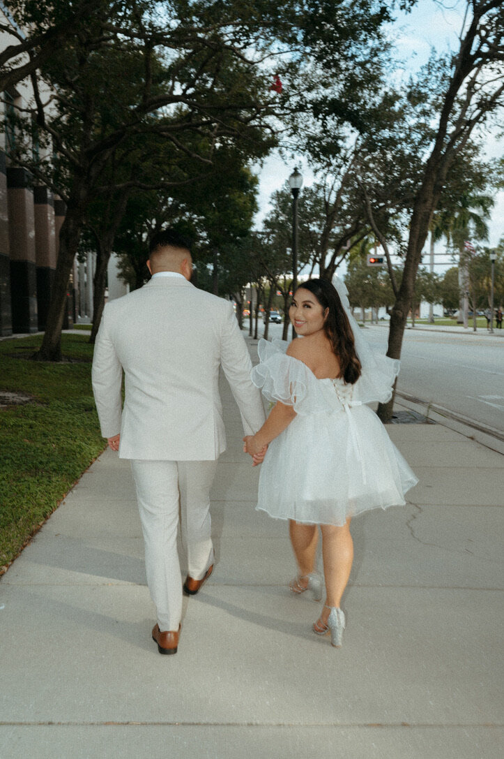 intimate elopement photos of couple holding hands downtown