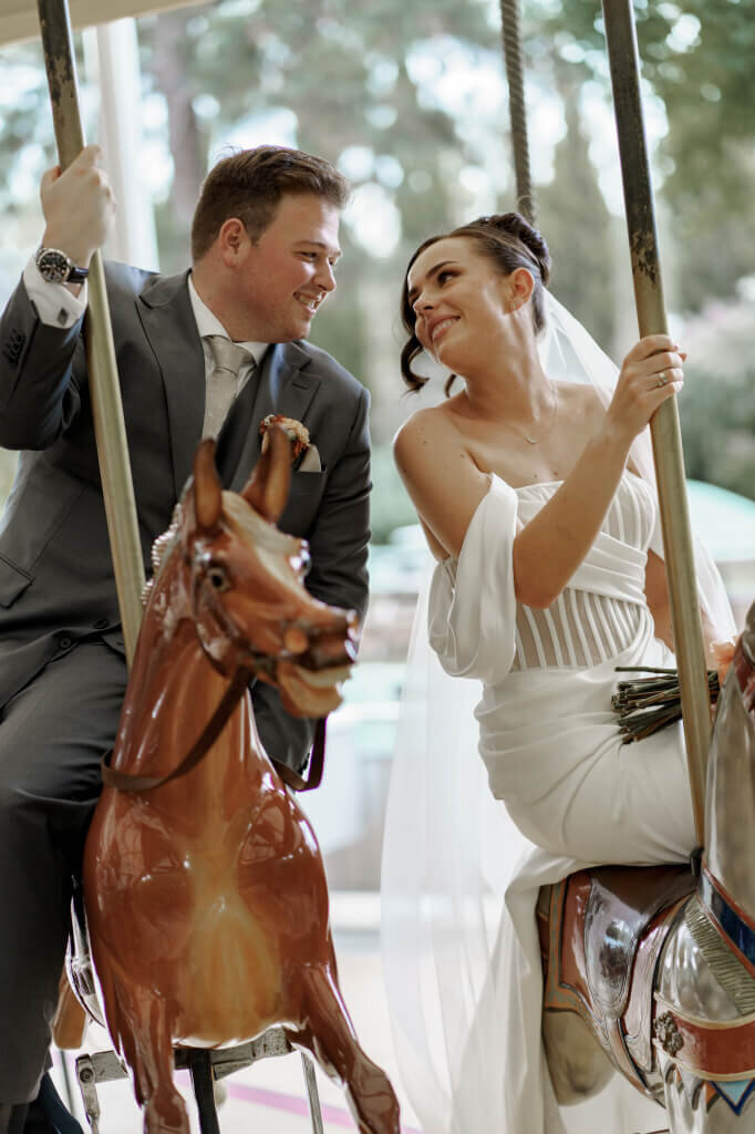 bride with bow on dress walking up stairs with husband