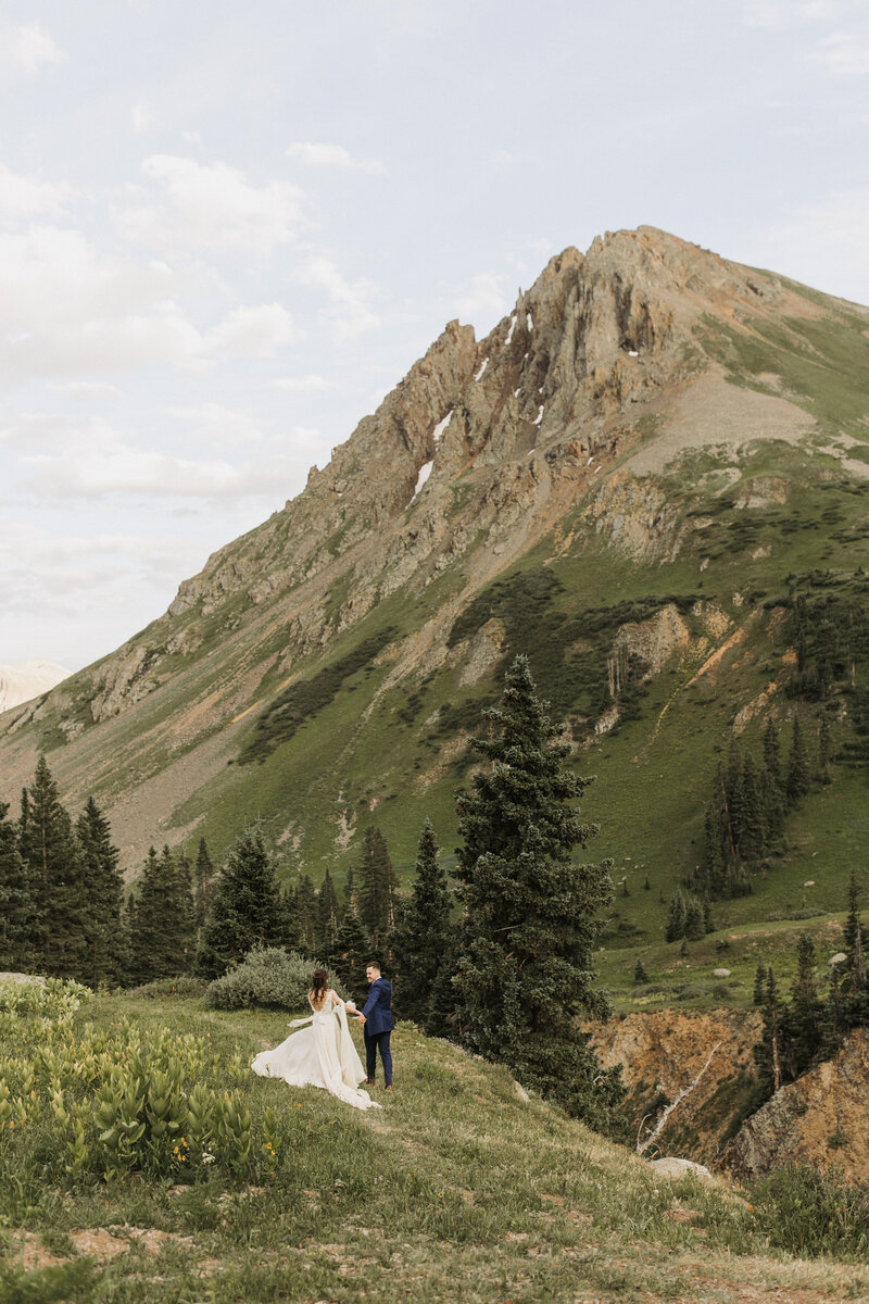 Elopement couple walking in the mountains of Ouray, Colorado during summer