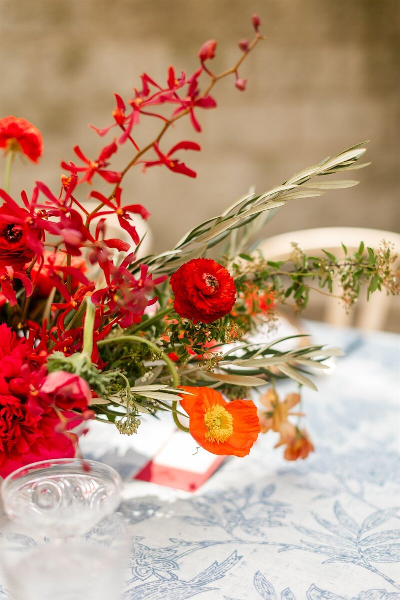 Elegant table setting with a detailed menu and vibrant floral centerpiece, designed by Chicago wedding planner Savoir Fête.