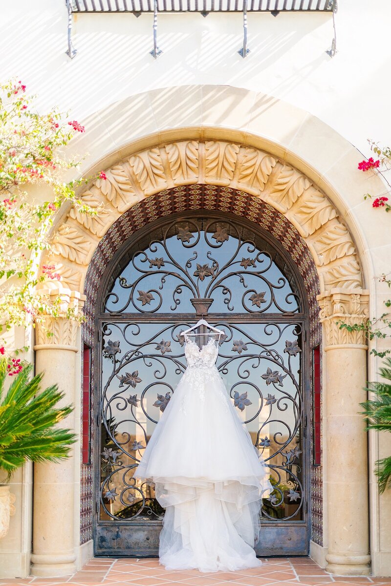 Bride's wedding gown hanging on doors at Hummingbird Nest Estate in Santa Susana, California.