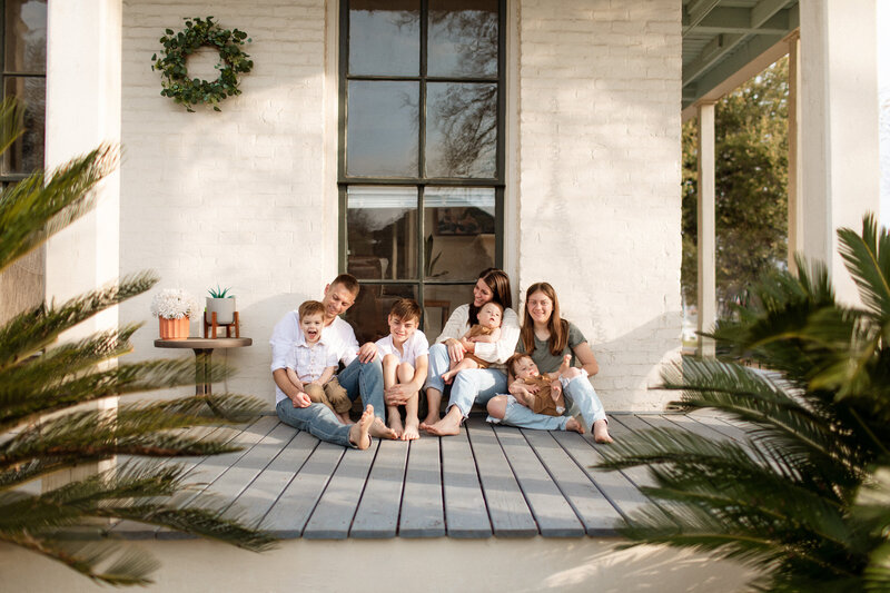 San Antonio family photography, family of 5 smiles together on a blanket in a glowing field