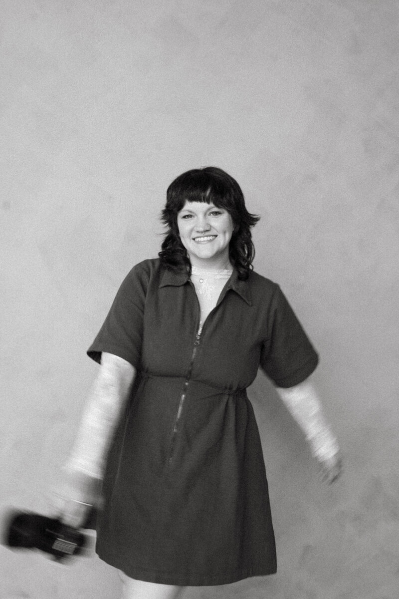 Inclusive wedding and elopement photographer based in Ohio, Wilder Photography, playfully poses for headshots