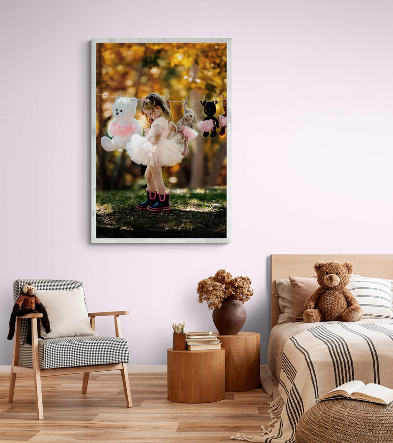 Little girls bedroom with her own picture framed on the wall, taken by family photographer Danielle Dott in Houston, Texas.