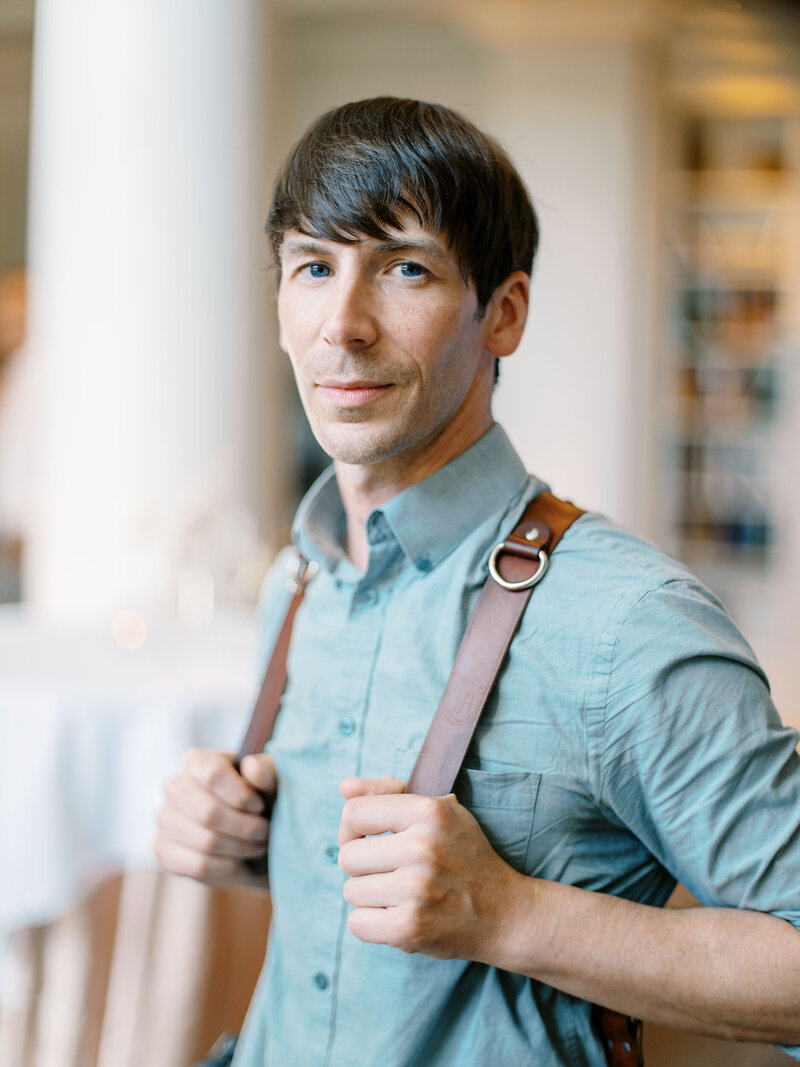 male wedding photographer with brown leather holdfast straps at woodmark hotel