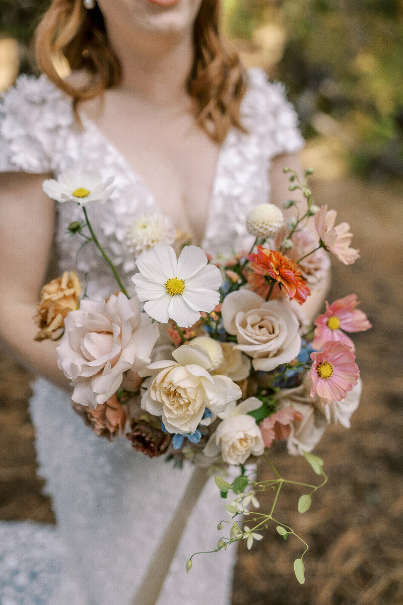 A faceless bride holding her wedding bouquet, representing the attention to detail offered by Oregon wedding photographer Among the Oaks. 