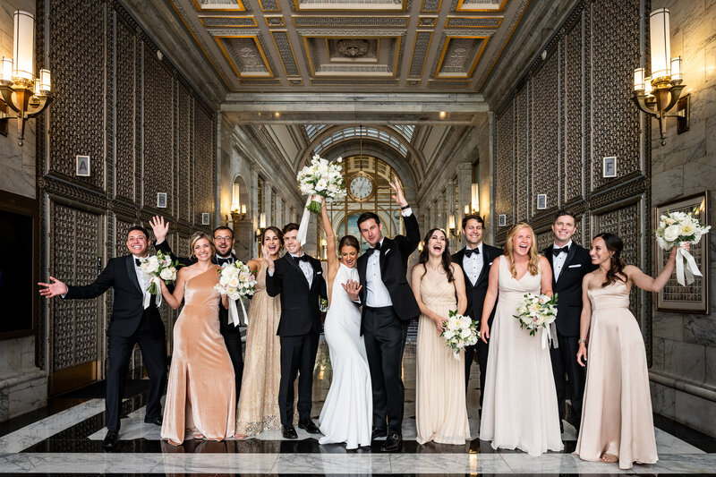 San Francisco wedding photographer captures elegant group portrait at Merchants Exchange Building with classical architectural backdrop