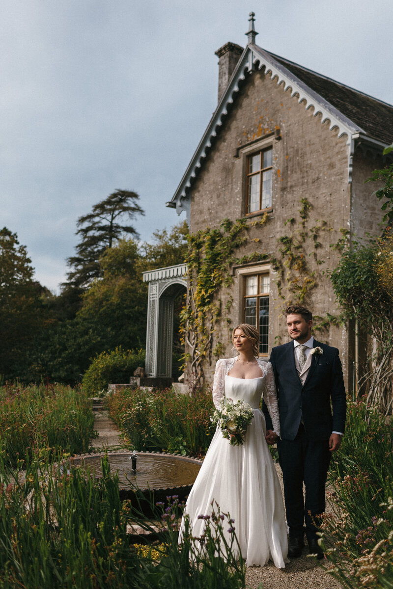 Couple pose for a photo at theri wedding in great light in Devon wedding venue Hotel Endsleigh