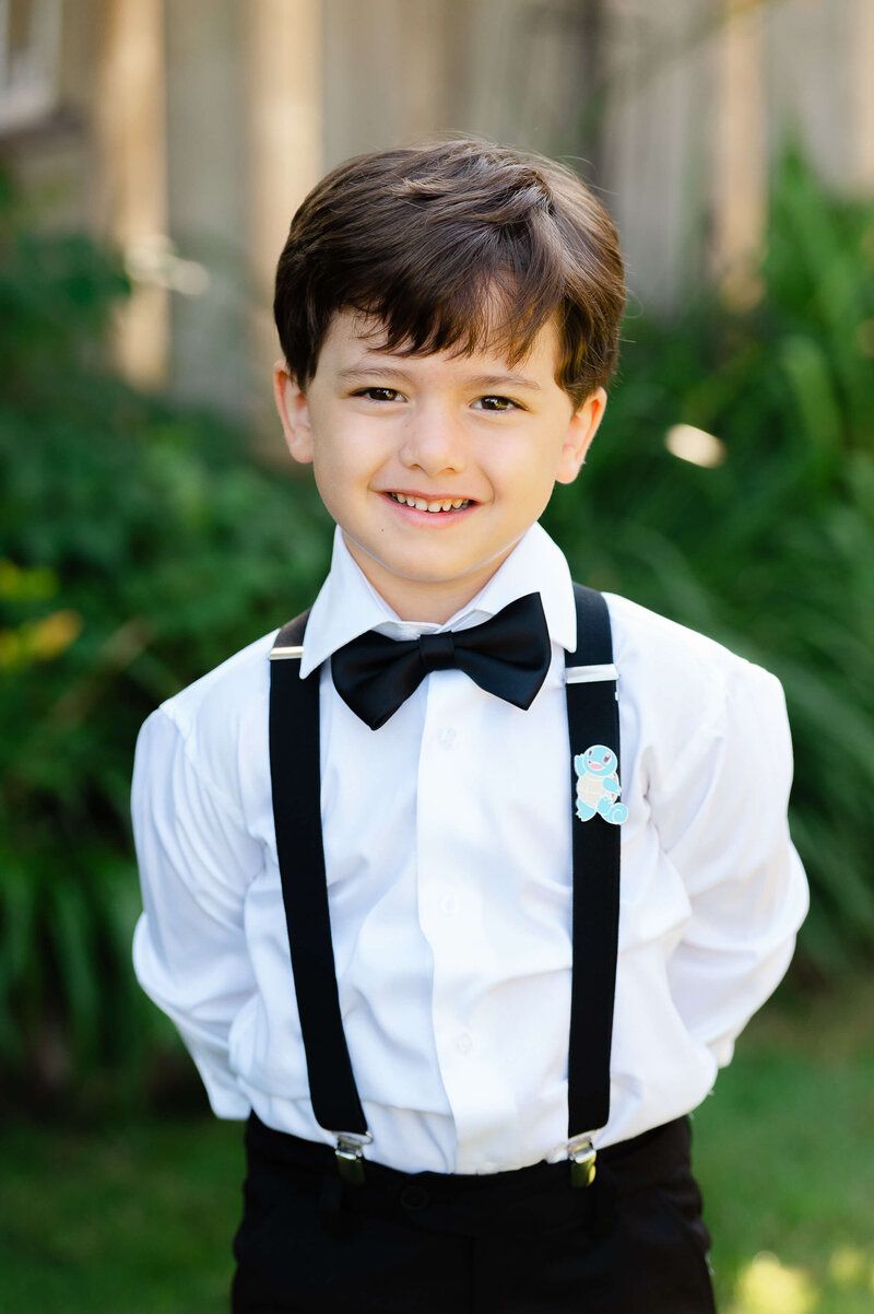Ottawa wedding photo of a ring boy in tuxedo suspenders.  Taken by JEMMAN Photography