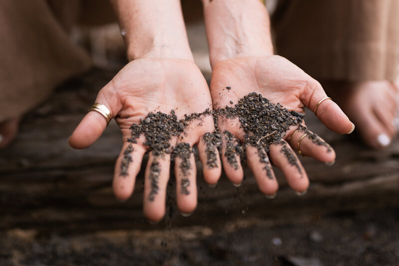 yoga teachers hand open wide with dirt