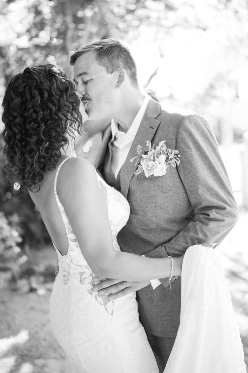 Bride and groom kissing  outside church in Naples Florida