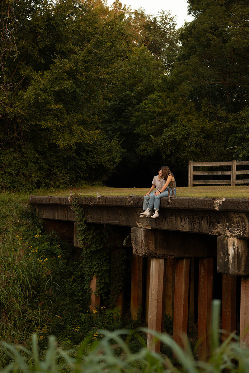 lgbt couple sitting on bridge talking