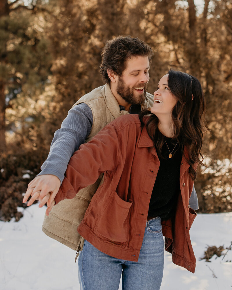 Couple having fun during winter engagement session.