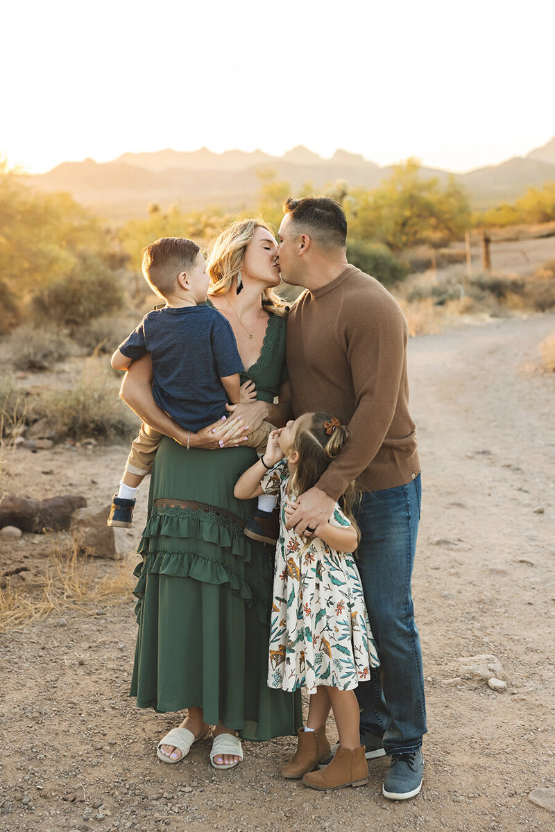 Children watching their parents kiss in a field in Fort Collins, Colorado