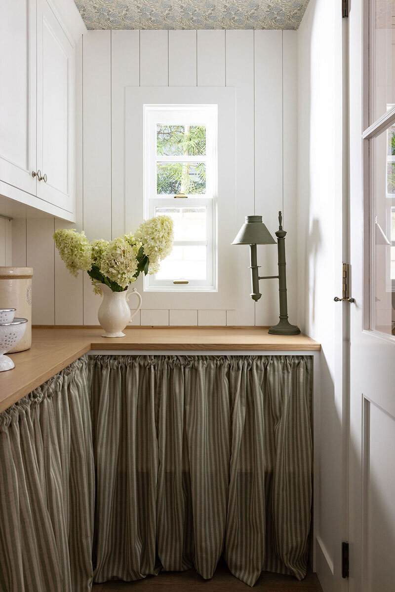 Classic California cottage nook room with neutral palette and warm wood accents in Newport Heights
