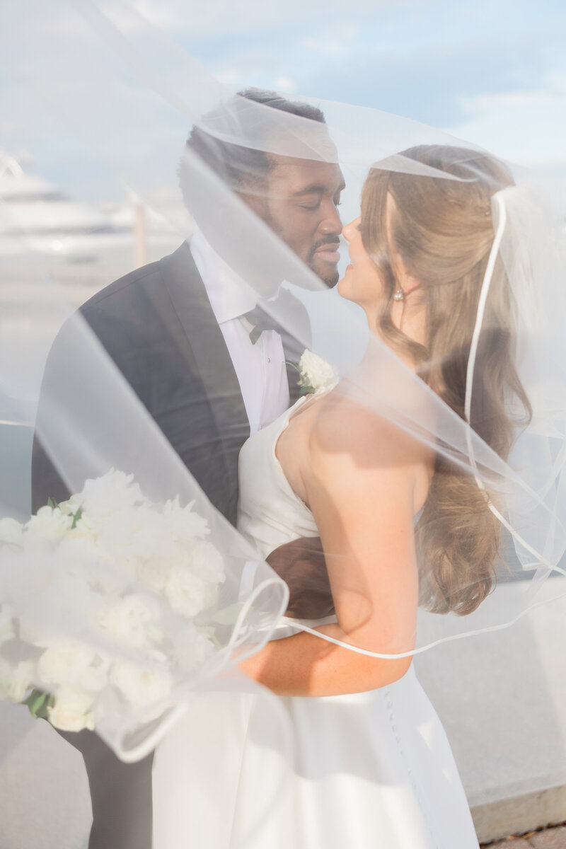 A couple under a veil at the Ben, The Autograph Collection in West Palm Beach.